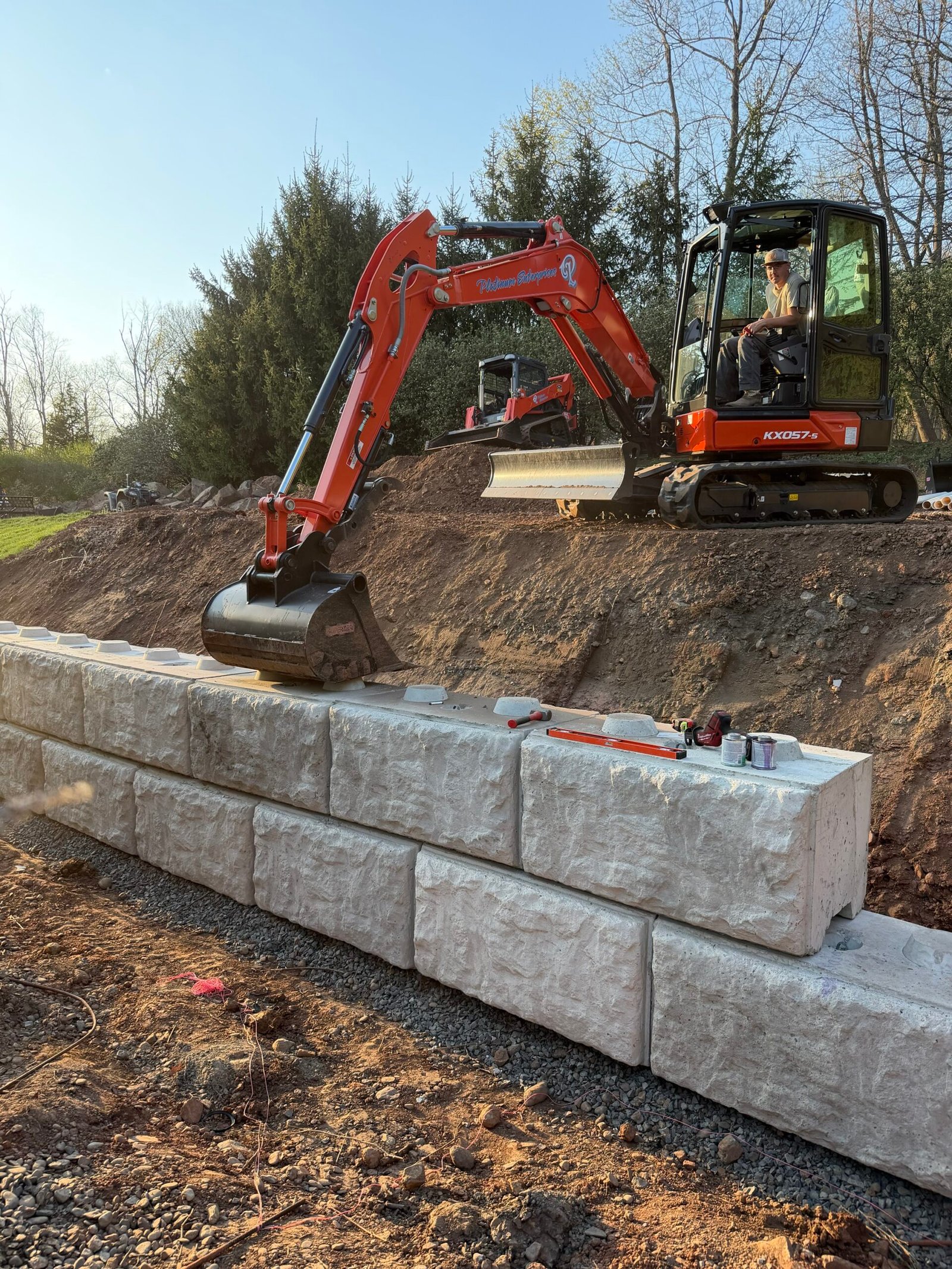 Kubota excavator building a retaining wall